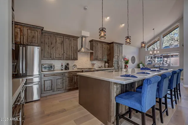 a kitchen with kitchen island a sink stove and refrigerator