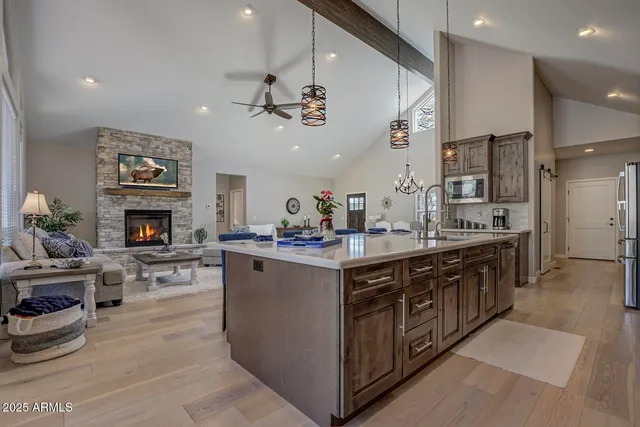 a large kitchen with cabinets a counter and chairs