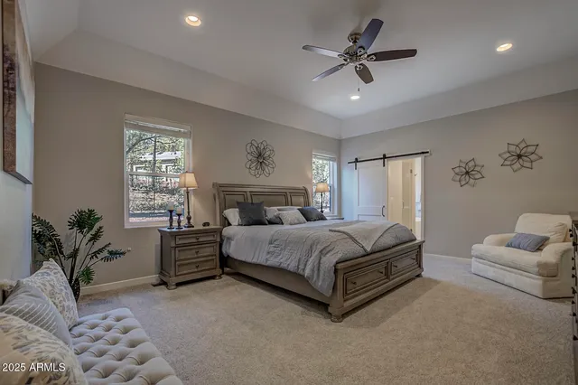 a spacious bedroom with a bed and a couch