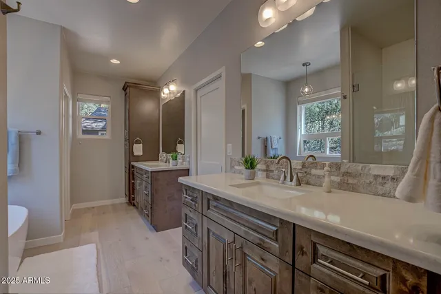 a bathroom with a sink double vanity and a mirror