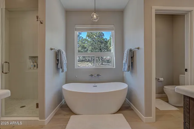 a bathroom with a white tub shower and sink