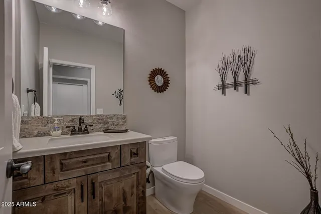 a bathroom with a sink vanity mirror and toilet