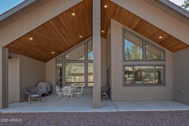a living room with furniture a window and glass doors