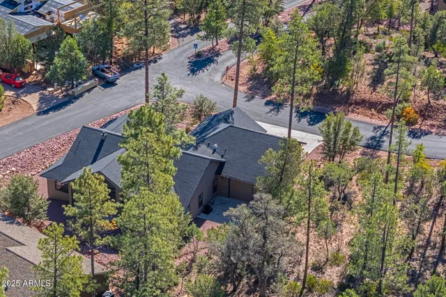 an aerial view of a house with a yard and garden