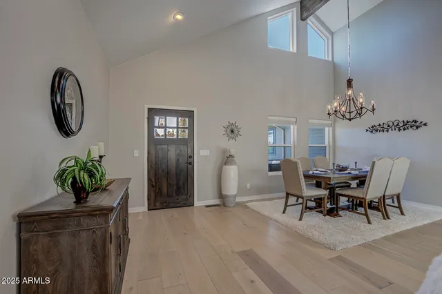 a view of a dining room with furniture and chandelier