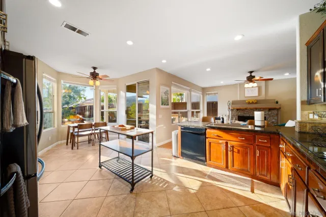 a kitchen with granite countertop a sink stove and cabinets