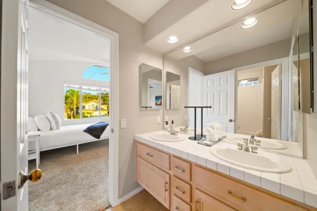 a bathroom with a double vanity sink mirror and