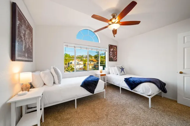 a bedroom with furniture and a large window