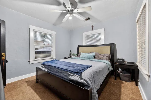 a bedroom with a bed and a television