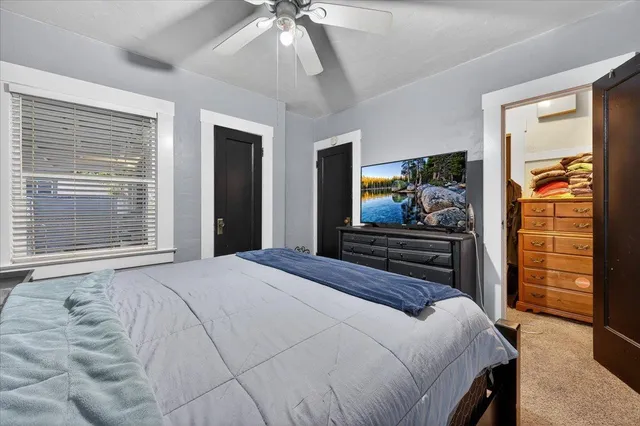 a bedroom with a bed and flat screen tv