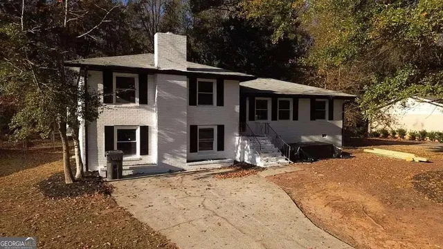 a front view of a house with a yard covered in snow