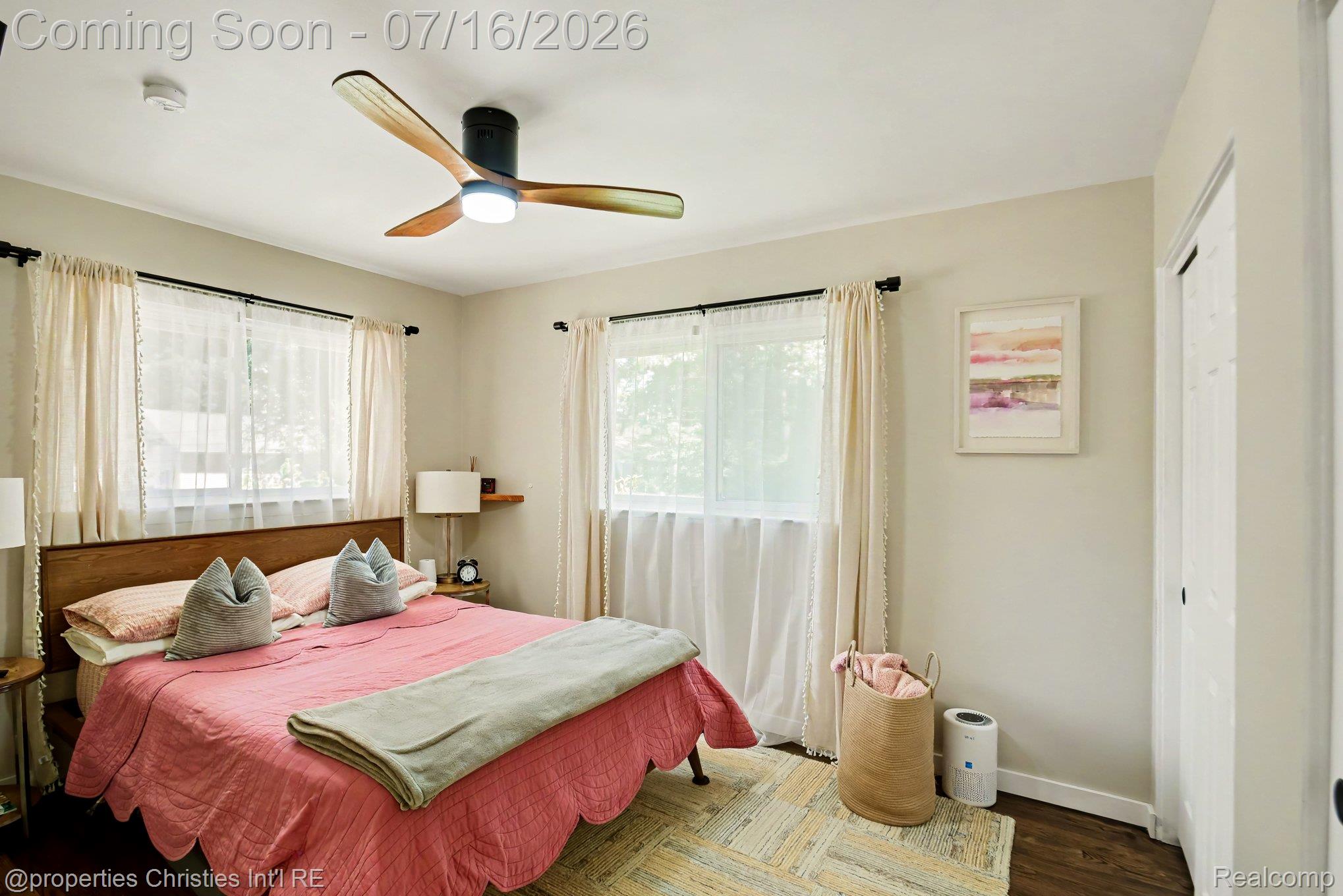 3304 Riverside Drive Port Huron, MI 48060 - Photo 16 of 26 Bedroom featuring two windows, a ceiling fan with light, wood-finish flooring, and white painted walls