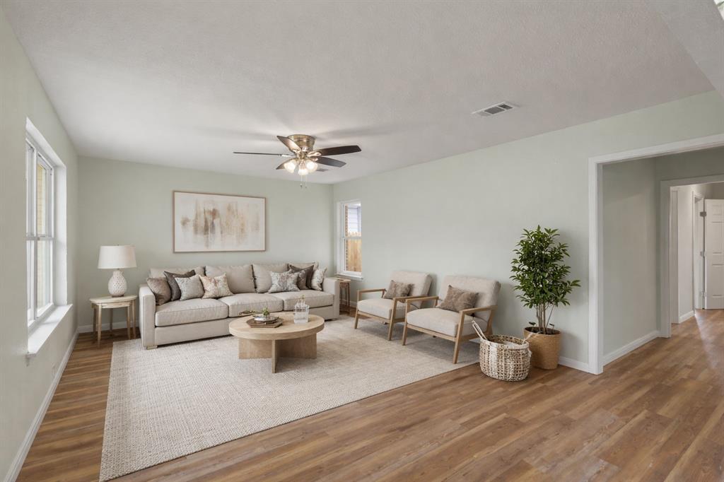 732 Bullock Street Denison, TX 75020 - Photo 2 of 29 a living room with furniture and a potted plant