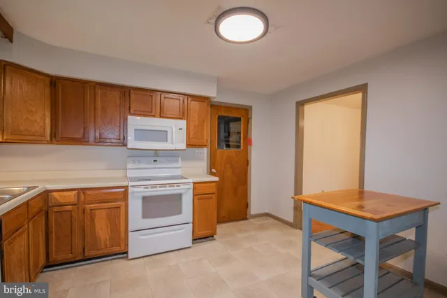 a kitchen with a stove and a sink