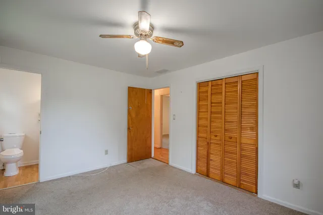 wooden floor in an empty room with a bathroom
