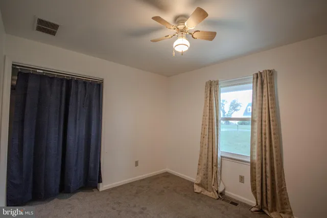 an empty room with closet area