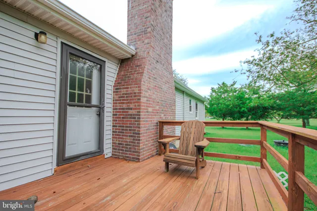 a deck with a bench and wooden floor