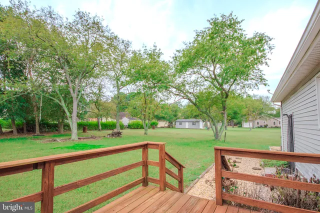 a view of a wooden deck with a yard