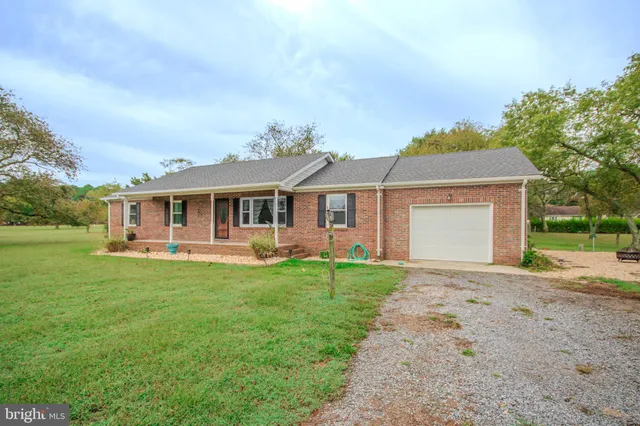 a front view of a house with a garden and porch