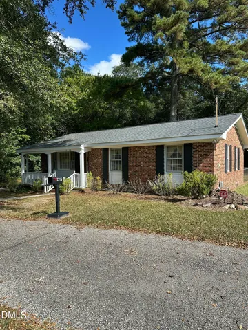 a front view of a house with a yard and porch