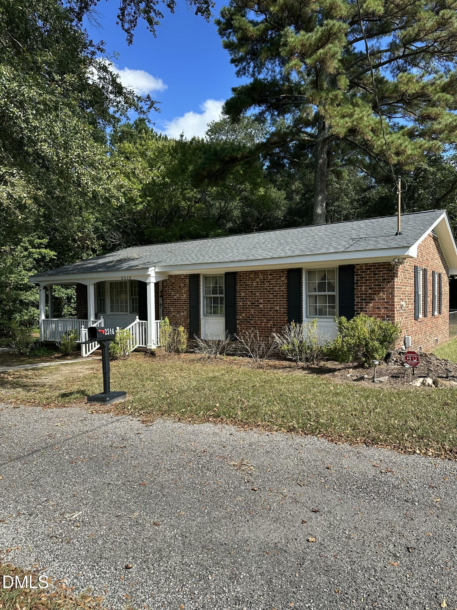 2516 Morphus Bridge Road Zebulon, NC 27597 - Photo 1 of 20 a front view of a house with a yard and porch