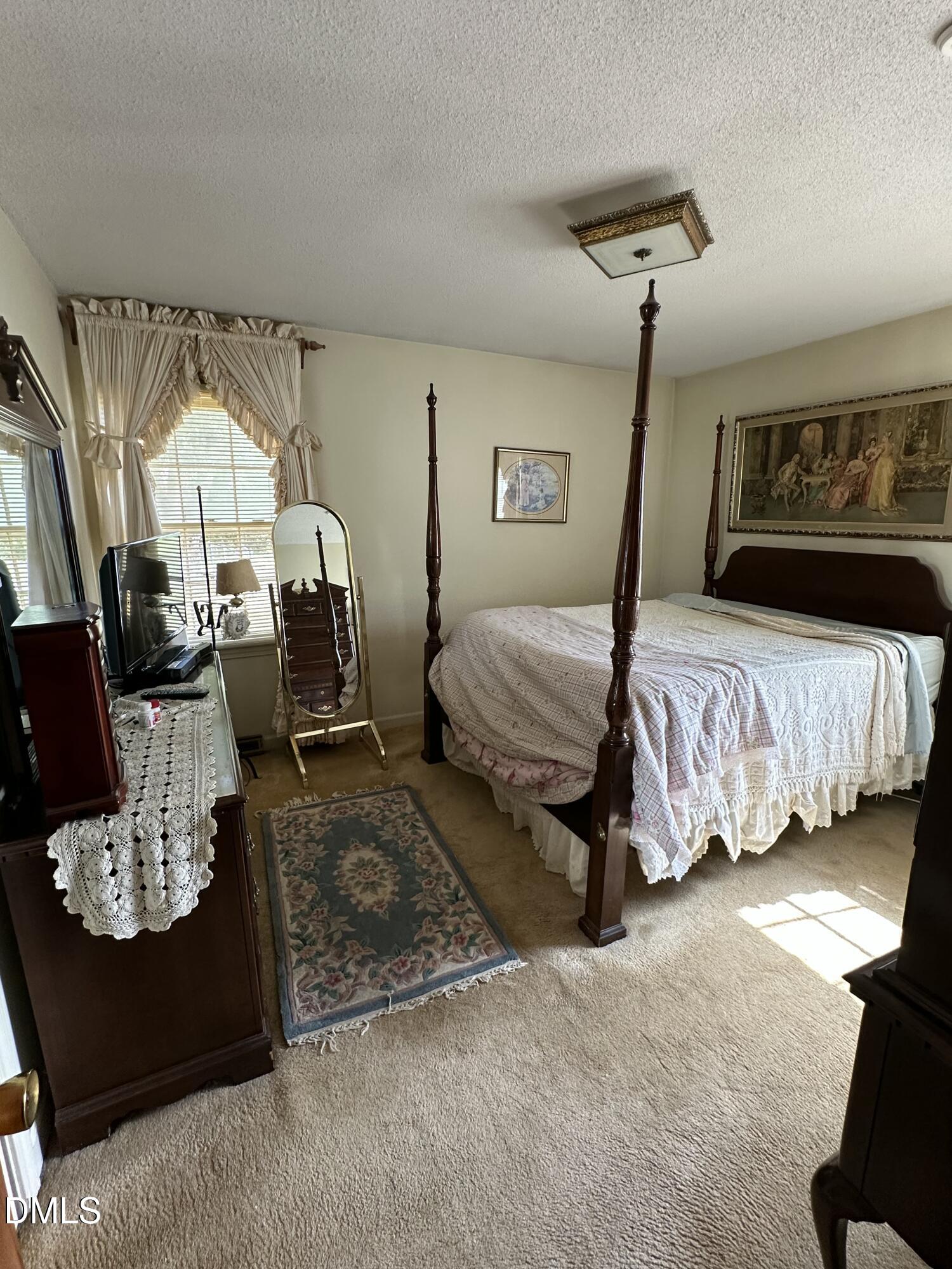 2516 Morphus Bridge Road Zebulon, NC 27597 - Photo 13 of 20 a bedroom with bed and window