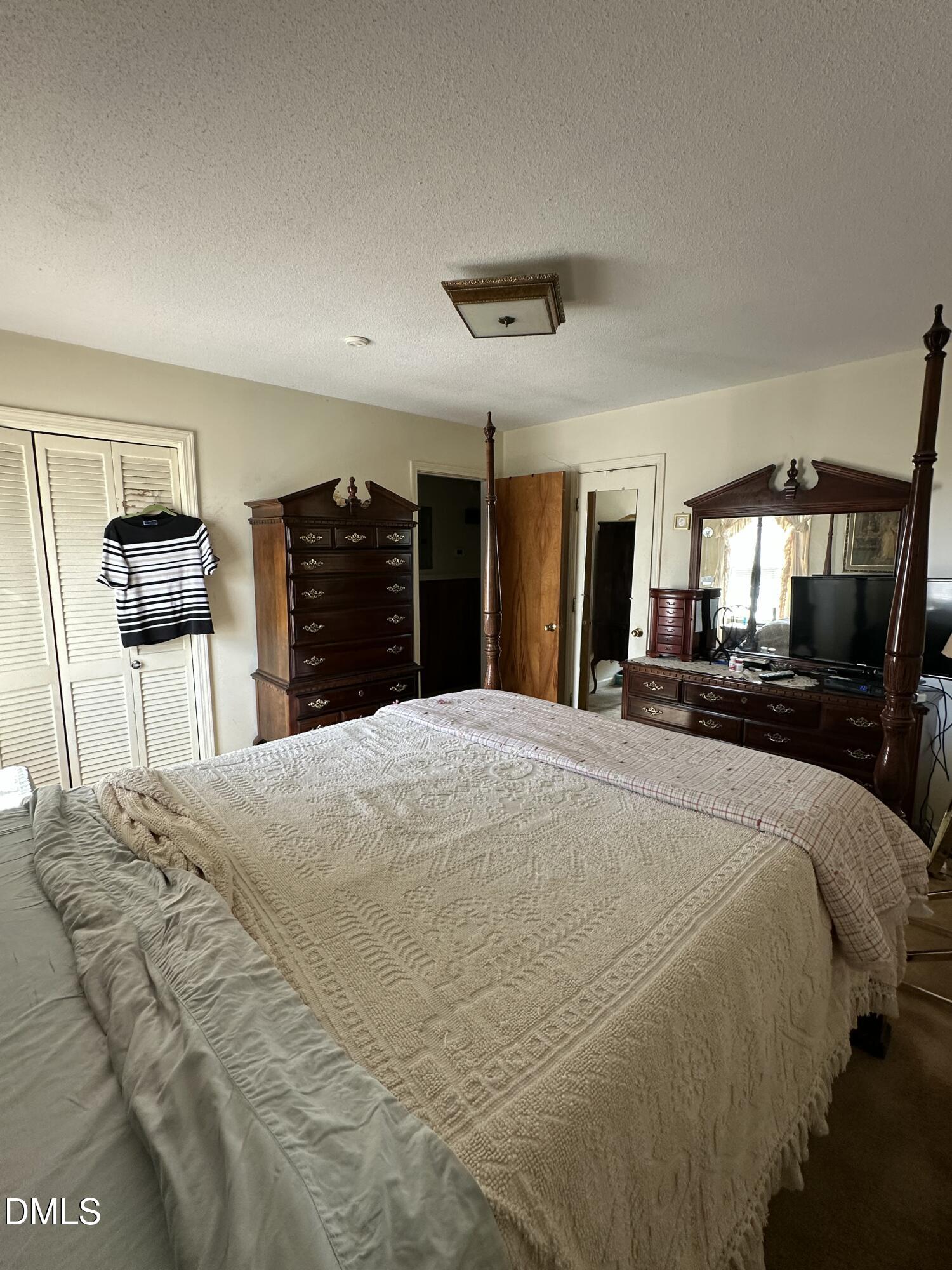 2516 Morphus Bridge Road Zebulon, NC 27597 - Photo 14 of 20 a large bed in a bedroom and a large mirror