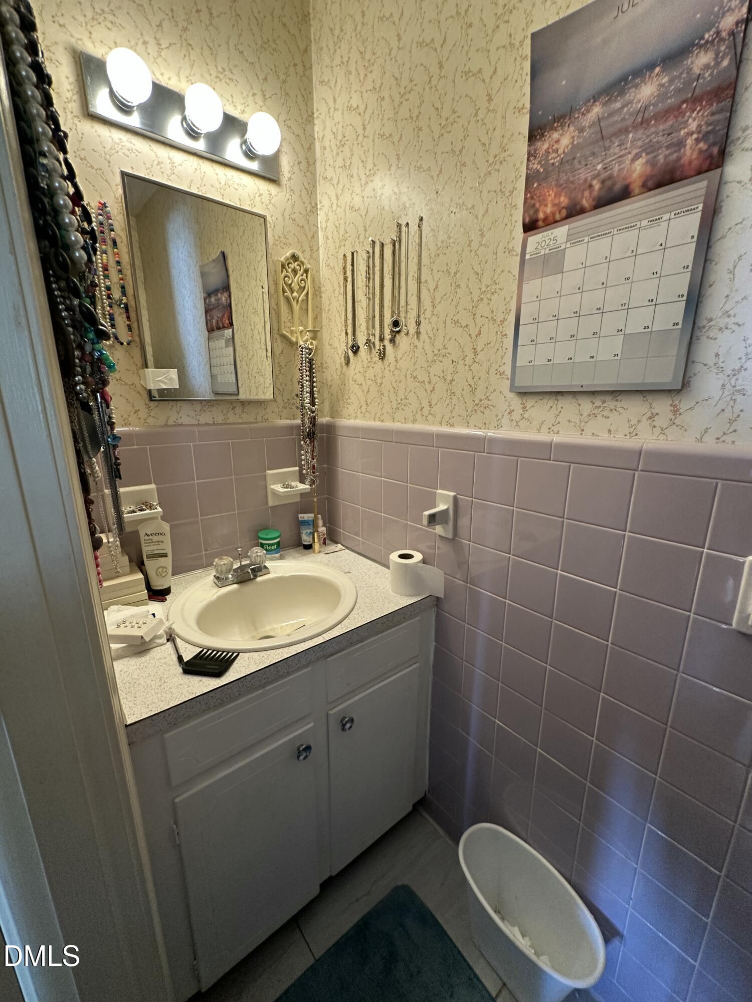 2516 Morphus Bridge Road Zebulon, NC 27597 - Photo 15 of 20 a bathroom with a sink and a mirror