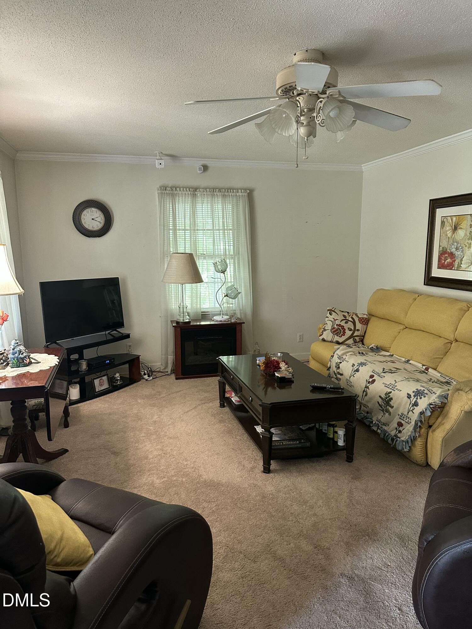 2516 Morphus Bridge Road Zebulon, NC 27597 - Photo 4 of 20 a living room with furniture and a flat screen tv