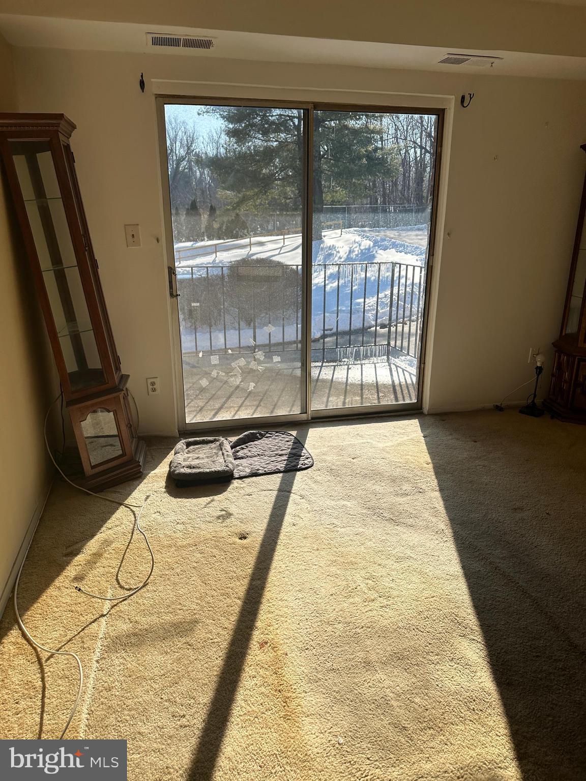 11908 Tarragon Road, Unit G Reisterstown, MD 21136 - Photo 2 of 45 a bed sitting in a bedroom next to a window
