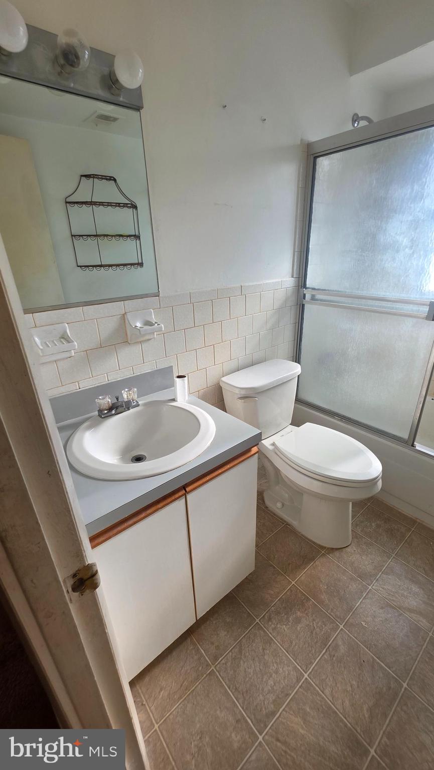 11908 Tarragon Road, Unit G Reisterstown, MD 21136 - Photo 21 of 45 a white toilet sitting next to a bathroom sink