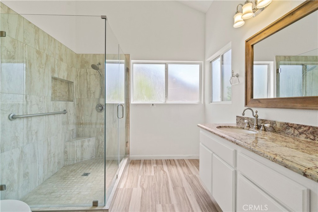 3367 Lathrop Avenue Simi Valley, CA 93063 - Photo 16 of 36 a bathroom with a granite countertop sink a shower and a mirror