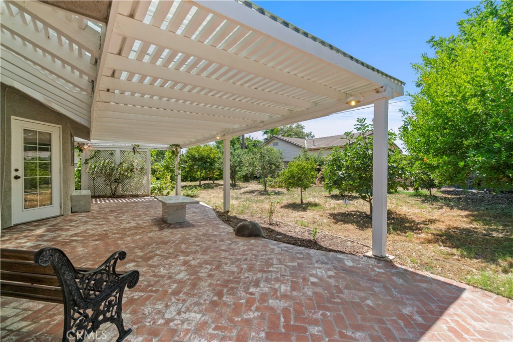 3367 Lathrop Avenue Simi Valley, CA 93063 - Photo 28 of 36 a view of a patio with table and chairs under an umbrella