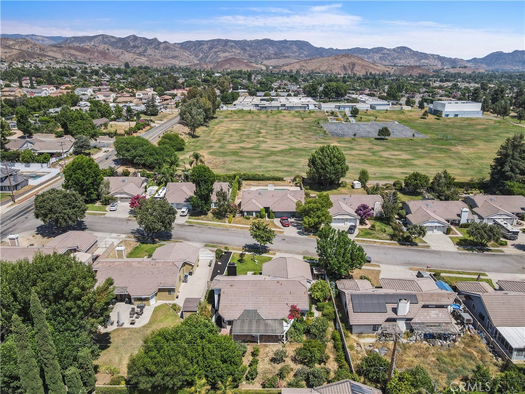 3367 Lathrop Avenue Simi Valley, CA 93063 - Photo 3 of 36 an aerial view of a city with lots of residential buildings and mountain view in back