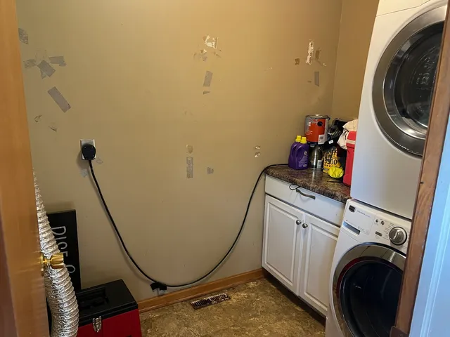 a view of a storage and utility room with dryer and washer