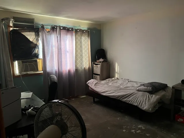 a bedroom with a bed and a flat tv screen