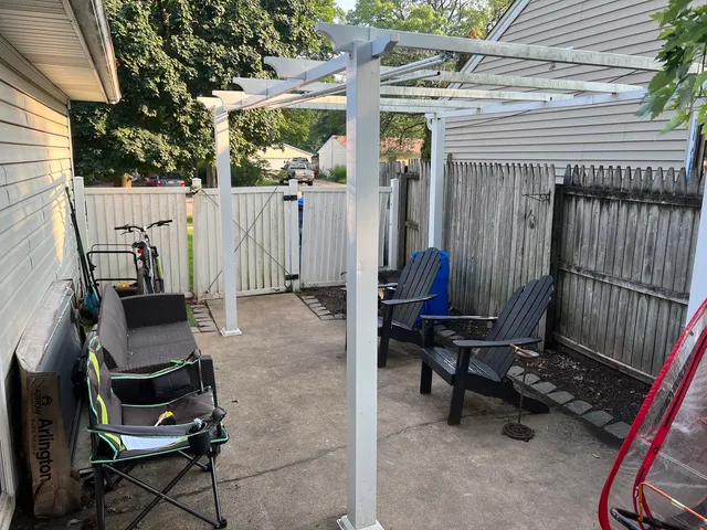 a view of backyard with a table and chairs