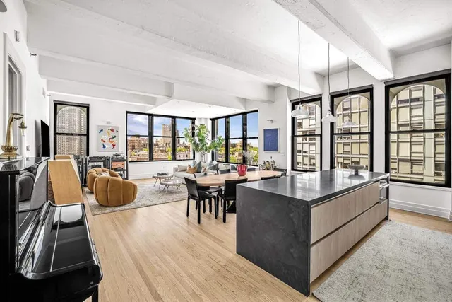 a living room with furniture large window and wooden floor