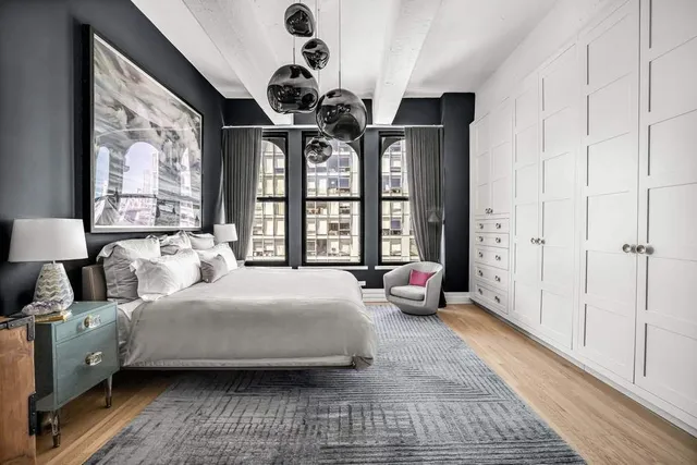 a bedroom with a large bed and a large window