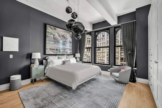 a bedroom with a large bed and a large window