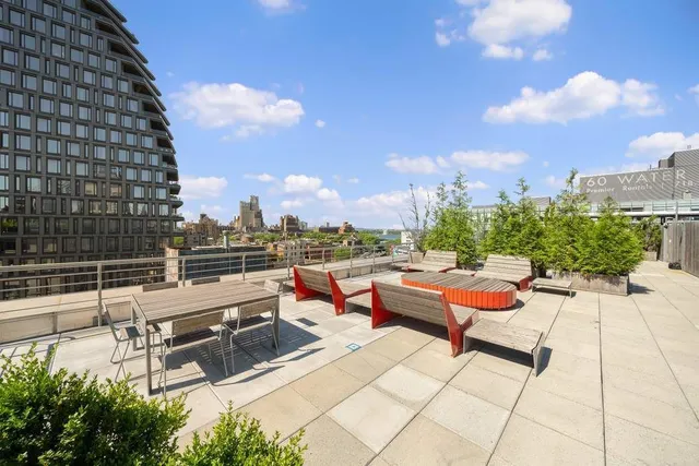 a terrace with outdoor seating and city view