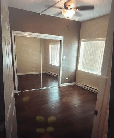 18154 Martin Avenue, Unit 4 Homewood, IL 60430 - Photo 4 of 5 an empty room with wooden floor and windows