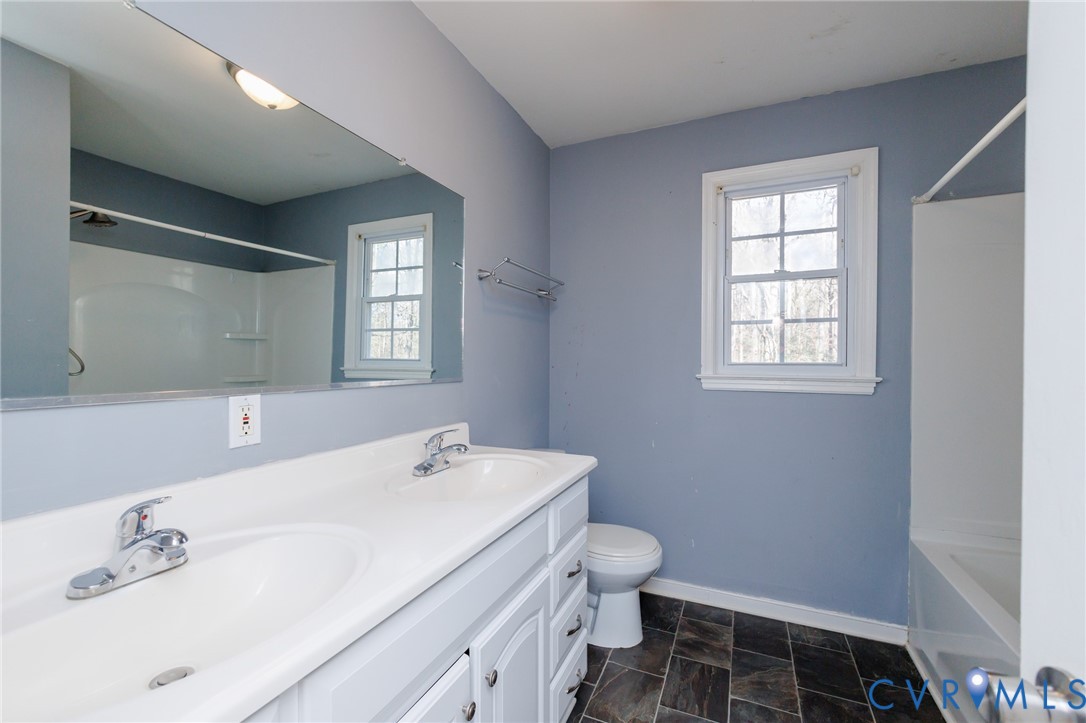 11515 Patillo Road Dewitt, VA 23840 - Photo 29 of 35 a bathroom with a sink toilet and window