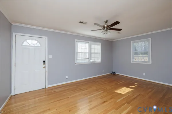 a view of a room with a ceiling fan and a window