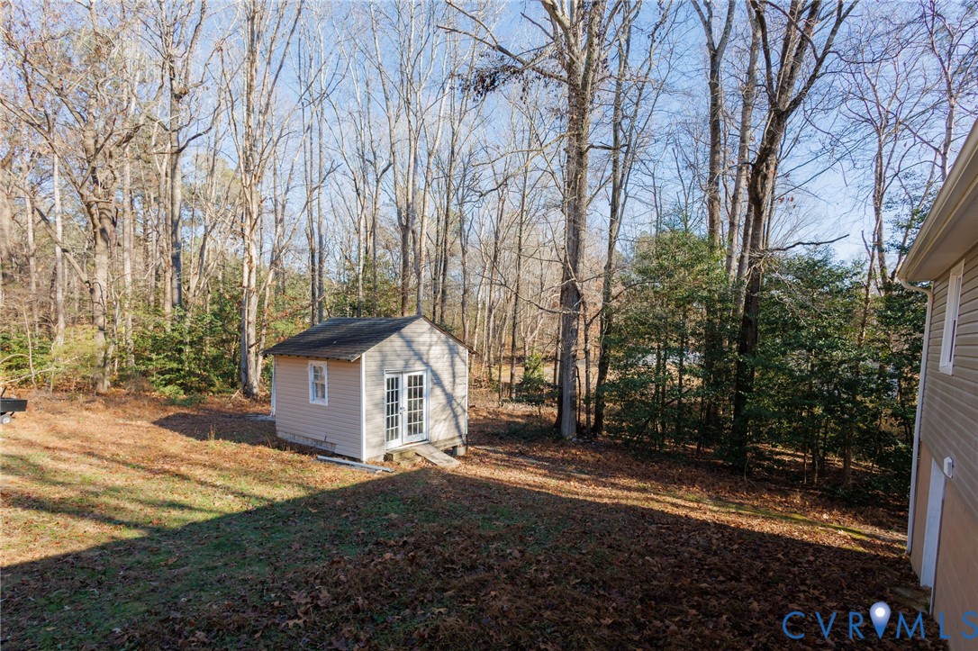 11515 Patillo Road Dewitt, VA 23840 - Photo 31 of 35 a view of a house with backyard and trees