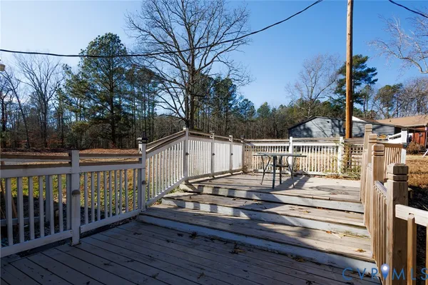 a view of a roof deck with wooden fence and floor