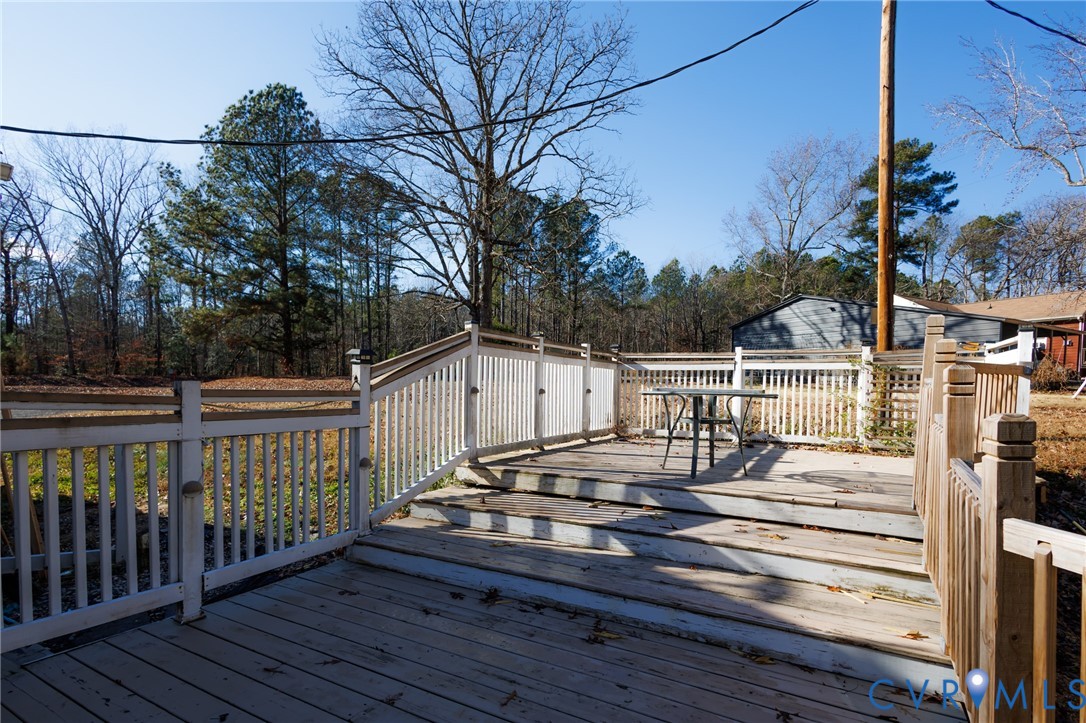 11515 Patillo Road Dewitt, VA 23840 - Photo 35 of 35 a view of a roof deck with wooden fence and floor