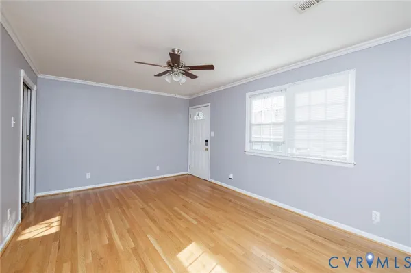 a view of room with window and ceiling fan