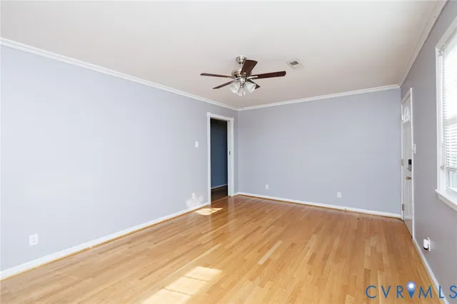 a view of room with wooden floor and ceiling fan