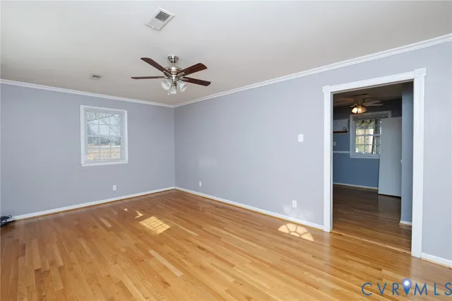 wooden floor in an empty room with a window